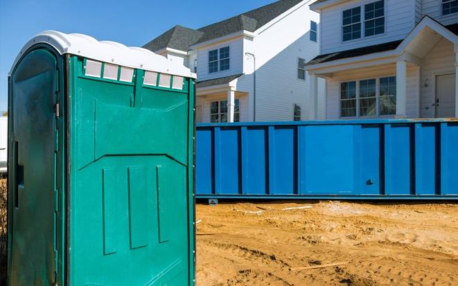 dumpster and portable toilet at a construction site in Deland FL